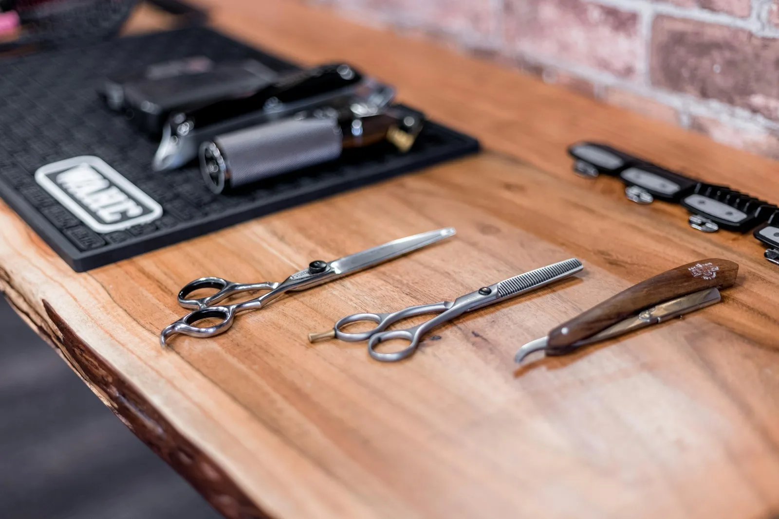 a wooden table topped with lots of different types of scissors